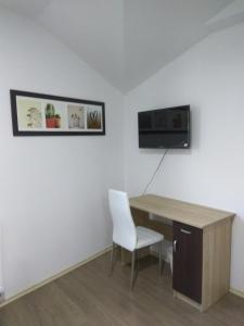 a room with a desk and a chair and a tv at Chill Out Wygryny in Ruciane-Nida +22 photos