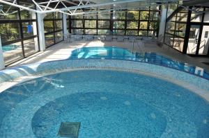 a large swimming pool in a building at Hotel Flores in Poreč