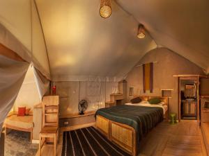 a bedroom with a bed in a tent at Nimmu House Ladakh in Nimu