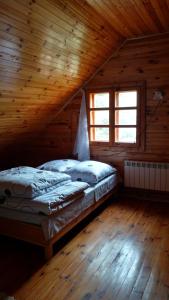 a bedroom with two beds in a wooden cabin at Dom Wakacyjny u Chmiela in Wołkowyja