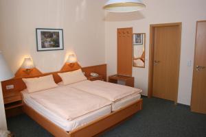 Postel nebo postele na pokoji v ubytování Hotel Petersen + 36 fotografií