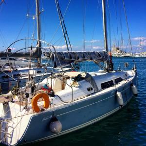 a sailboat is docked in the water in a harbor at Sailing Yacht Armida Rhodes in Rhodes Town