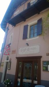 a building with a sign on the side of it at Dimora San Sebastiano in Neive