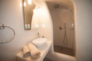 a white bathroom with a sink and a shower at Lefteris Traditional Rooms in Fira +41 photos