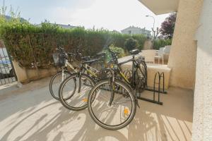 two bikes are parked next to a building at Apartamentos Massol in Port de Pollensa