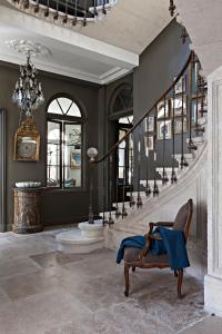 a room with a staircase with a blue cloth on a chair at La Divine Com&eacute;die-Suites Deluxe in Avignon