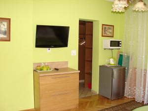 a living room with a flat screen tv on a wall at Kalina in Zakopane