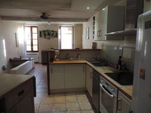 a kitchen with a sink and a stove top oven at Le logis de la Fontaine in Ceyreste