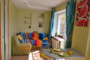 a living room with a couch and a table at Catedra View Apartment in Ternopil