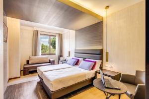 a bedroom with a bed and a laptop on it at Warmthotel in Rome