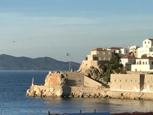 a group of buildings on the shore of the water at Pension Efie in Hydra