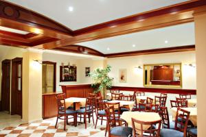 a restaurant with tables and chairs in a room at Philippos Hotel in Paralia Katerinis