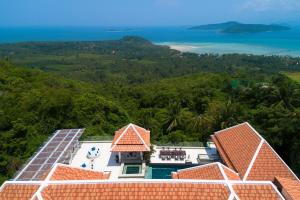 an aerial view of a house with solar panels on the roof at Nirvana Villa & Boutique Hôtel in Taling Ngam Beach