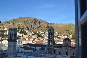 a view of a city with a mountain in the background at Pension Efie in Hydra
