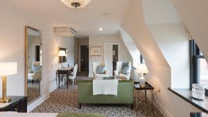 a living room with a couch and a table at Sydney Boutique Inn & Suites in Charlottetown