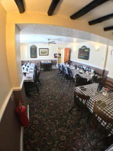 a restaurant with tables and chairs in a room at The Fox & Hounds Inn in West Burton