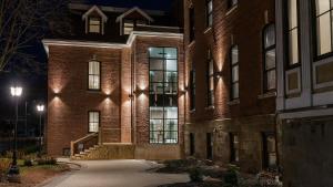 a brick building at night with its lights on at Sydney Boutique Inn & Suites in Charlottetown