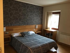 En eller flere senge i et værelse på Hotel Errekagain