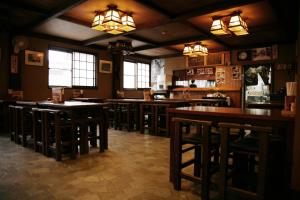 a bar with wooden tables and chairs in a restaurant at Magome Chaya in Nakatsugawa