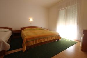 Postel nebo postele na pokoji v ubytování Apartments Macolic