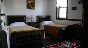 a bedroom with two beds and a window at Hotel Klea in Berat