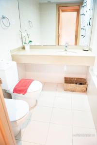 a white bathroom with a sink and a toilet at Alcam Aribau in Barcelona