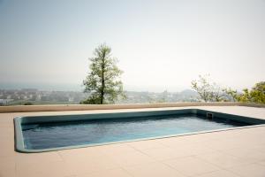 a swimming pool on the roof of a house at Apartamenty in Veseloe in Adler