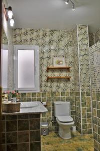 a bathroom with a toilet and a sink at Apartamento Royal Centro de Ronda in Ronda +57 photos