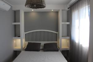 a bed with two pillows on it in a bedroom at B&B Bessy 10 in Antibes