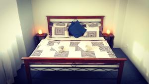 a bed in a room with two candles on two tables at Prague 7days Apartments - FREE PARKING in Prague