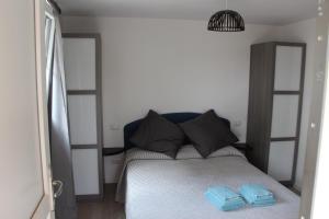 a bedroom with a bed with two blue towels on it at B&B Bessy 10 in Antibes