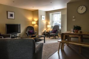 a living room with chairs and a flat screen tv at The House at Glenbarr Stores in Glenbarr