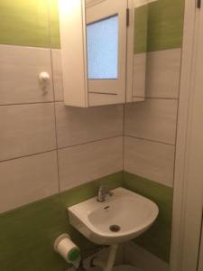 a small bathroom with a sink and a mirror at Orfeas Rooms in Vasiliki +64 photos