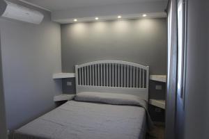 a small bedroom with a bed and a window at B&B Bessy 10 in Antibes