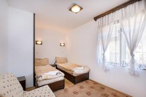 a room with two beds and a window at Къща за гости "При Примо" in Zlatograd