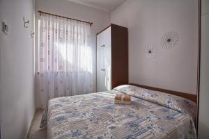 a bedroom with a bed and a dresser at Apartment Rosy in Pula +22 photos