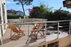 two chairs and a table on a deck at B&B Bessy 10 in Antibes