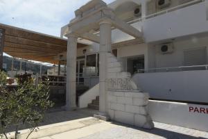 a building with a sign on the side of it at Antonis Hotel in Kefalos