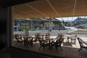 a view of a patio with tables and chairs at Antonis Hotel in Kefalos