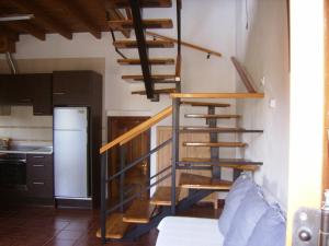a kitchen with a spiral staircase in a room at El Mirador de Valdedios " Casa Friera" in Puelles +37 photos