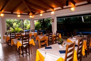 a restaurant with tables and chairs with yellow napkins at Pansion Ana in Mali Lošinj