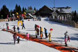 a group of people standing in the snow at Holiday Home Čumar in Cerkno