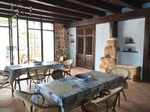 a dining room with tables and chairs and a stone fireplace at Villa Di Maria in San Vito lo Capo