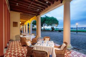 a restaurant with tables and chairs on a patio at Hotel del Parque in Guayaquil