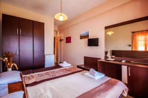 a bedroom with two beds and a sink and a mirror at Ulrika in Egina