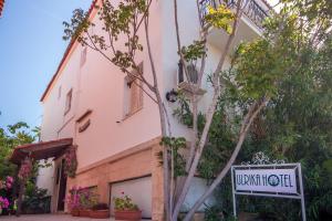 a building with a sign in front of it at Ulrika in Egina
