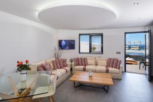 a living room with a couch and a table at Elea Resort - Adults Only in Oia