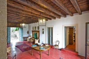 a living room with a wooden ceiling and a table at Relais Villa Ambrosetti in Verona