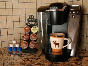 a coffee maker and a coffee cup on a counter at Montana Style Downtown Condo in Whitefish