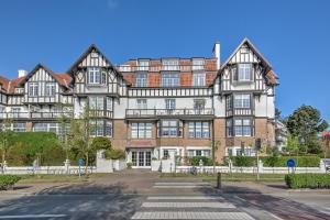 a large brick building with many windows at Res. Golf Zoute in Knokke-Heist